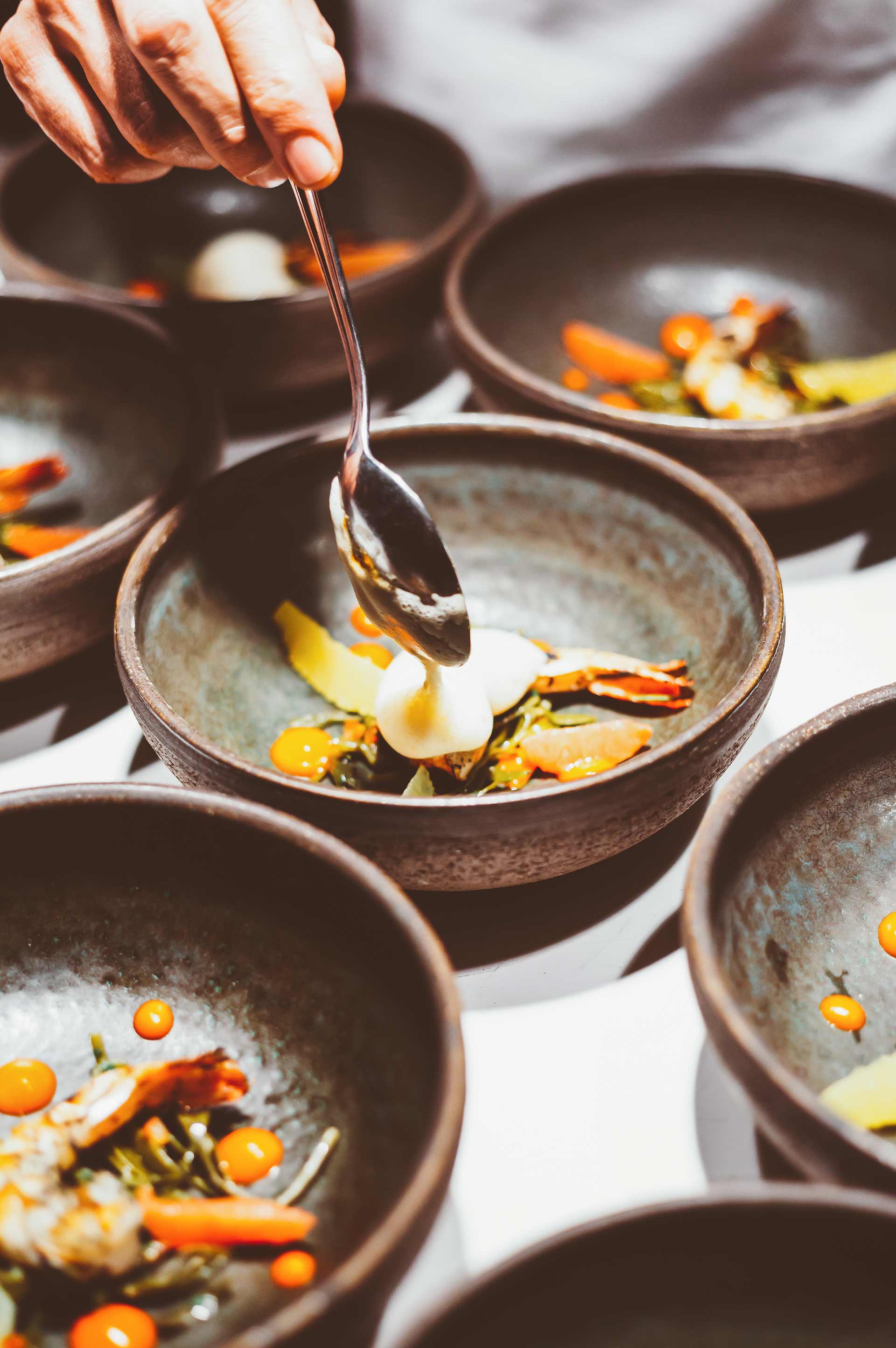 Chef plating small bowls for an event